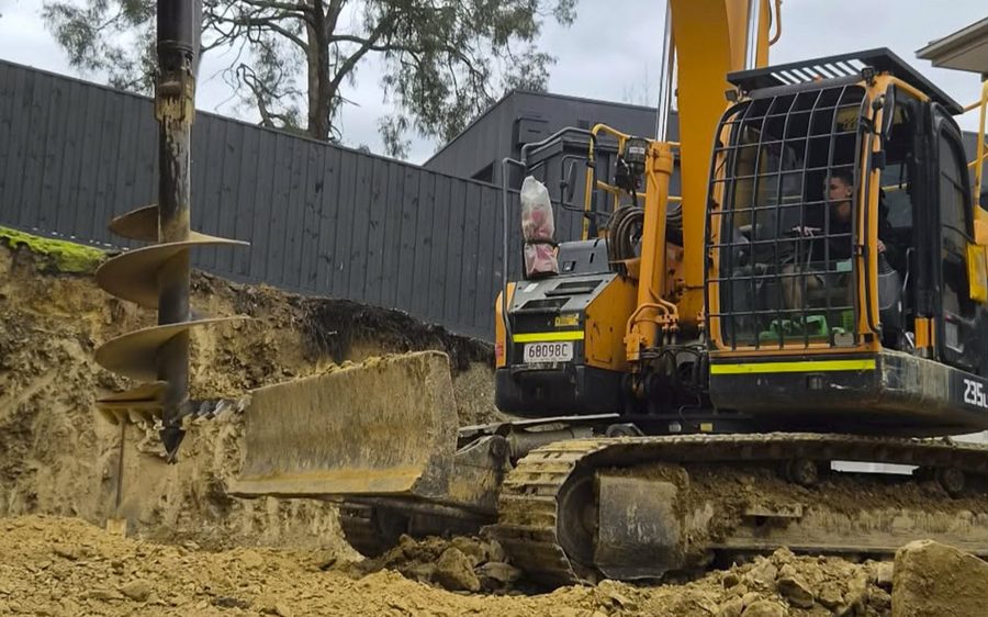 Auger drilling the footings for the steel posts