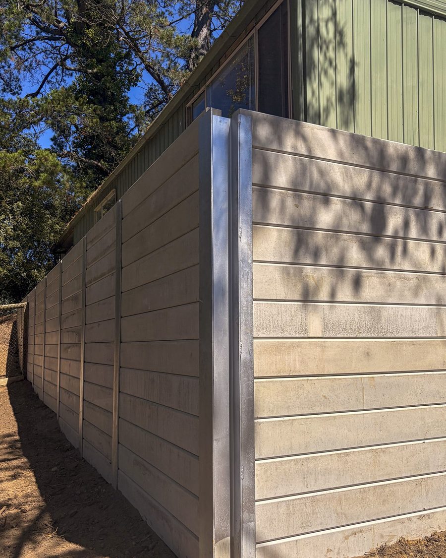 Completed concrete sleeper retaining wall along the boundary