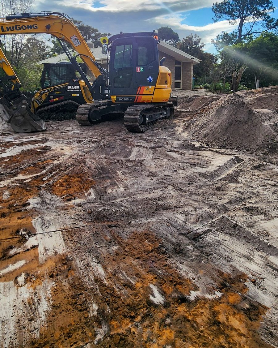 Plant working a cut with spoil stockpiled