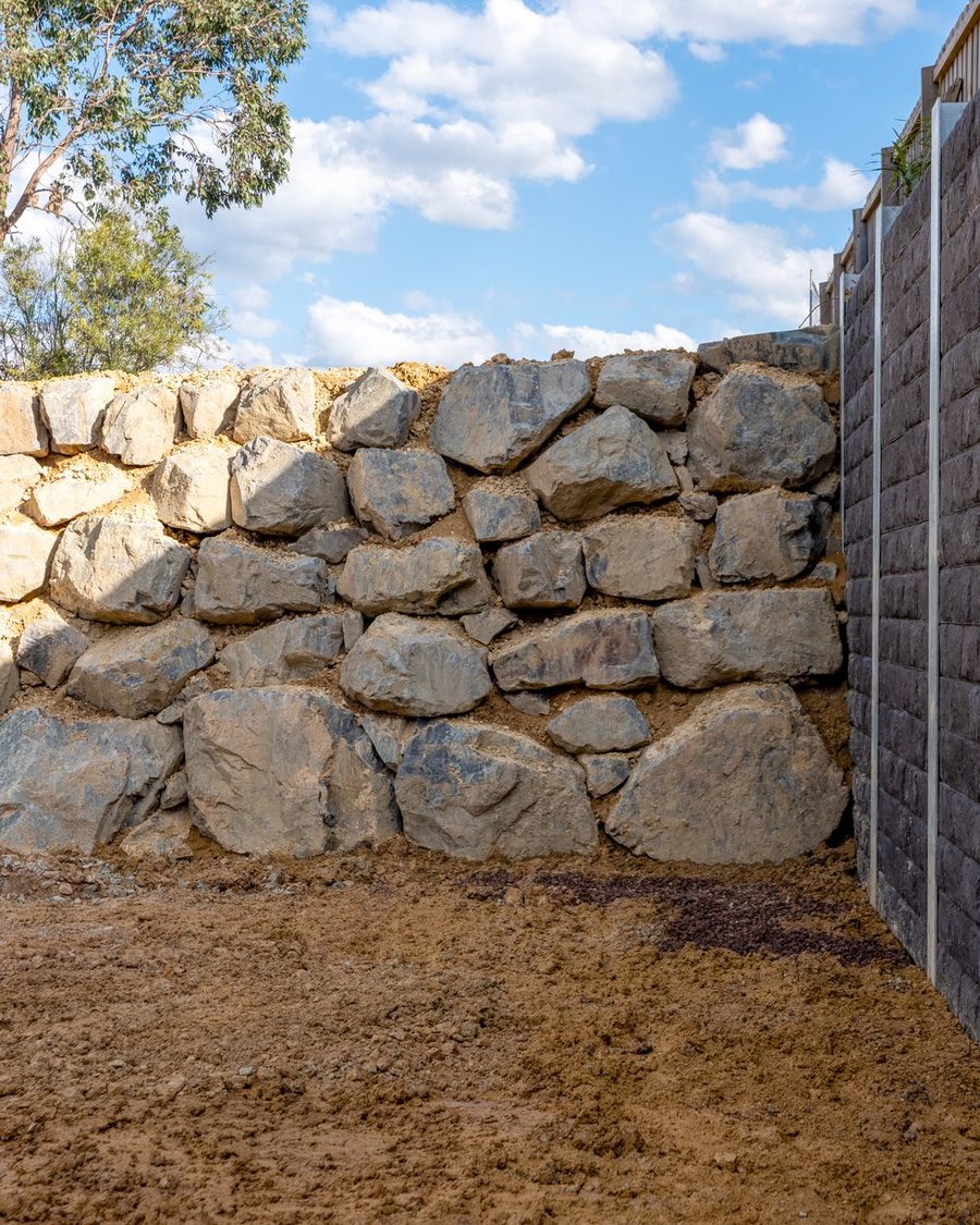 Finished quarry rock wall with the engineered sleeper wall behind it