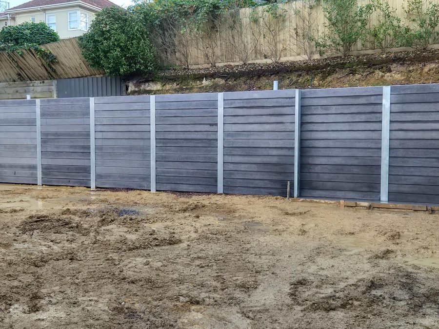 Concrete sleeper retaining wall on a boundary